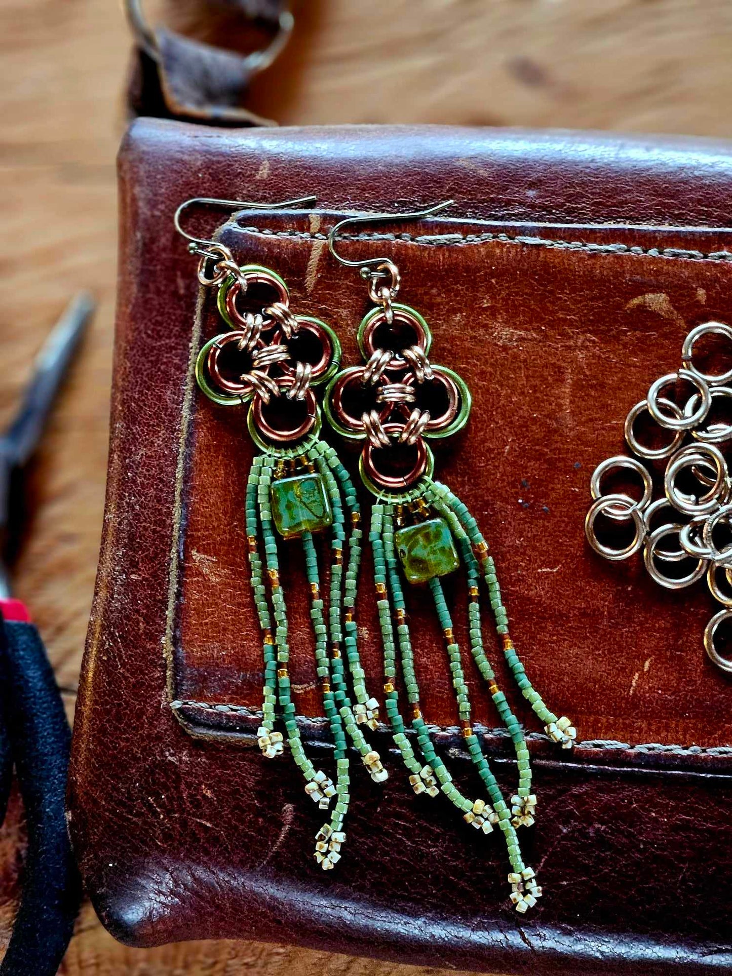 Elevate your style with our Green Japanese Cross Earrings. Handcrafted with a Japanese chainmaille design and Miyuki glass beads. Add a unique touch to your outfit.