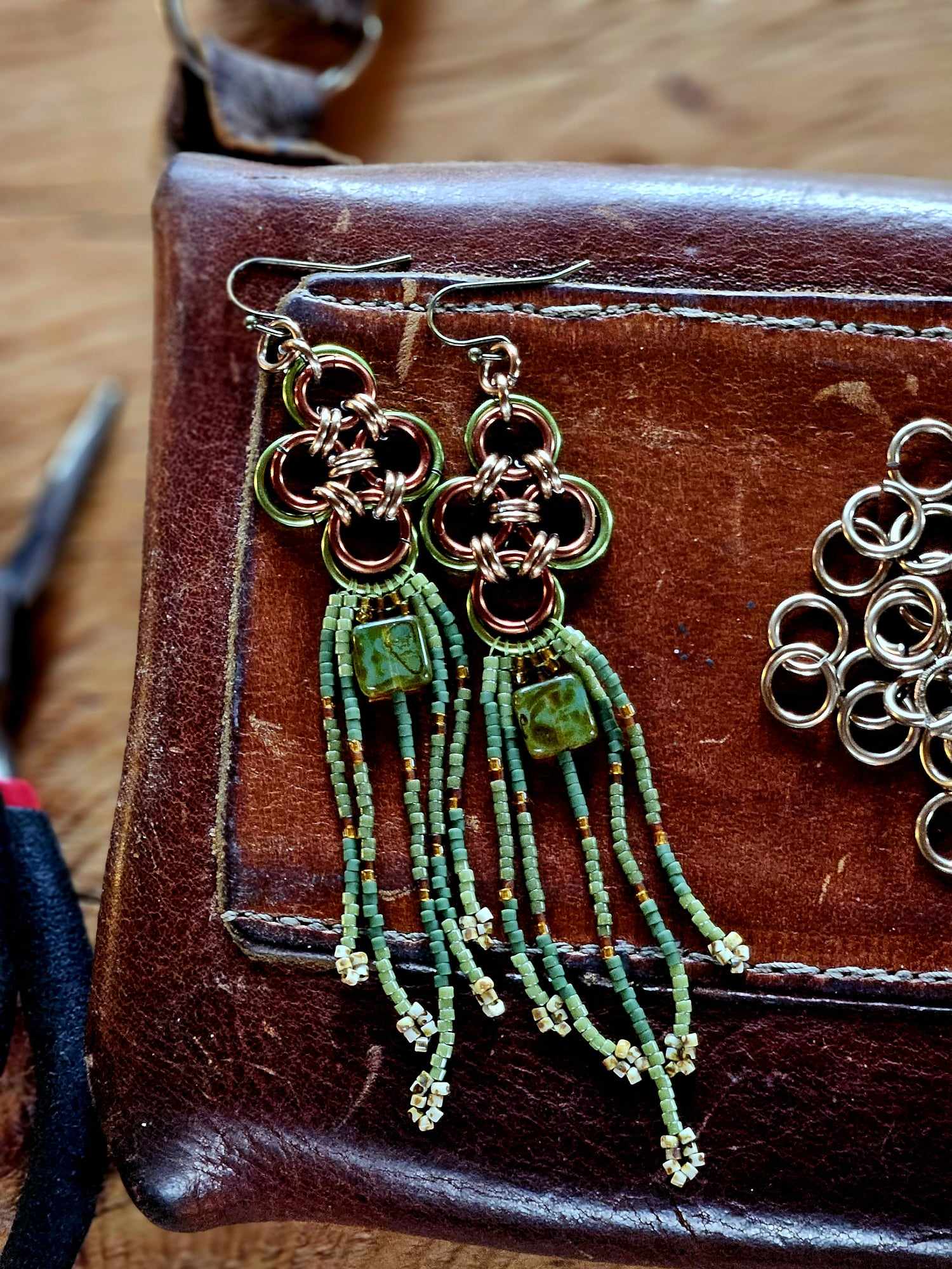 Elevate your style with our Green Japanese Cross Earrings. Handcrafted with a Japanese chainmaille design and Miyuki glass beads. Add a unique touch to your outfit.